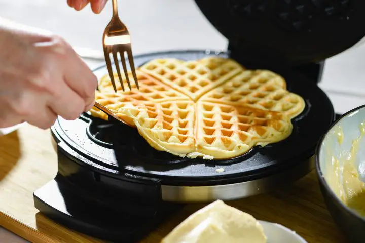 Waffle on black pan with white cream